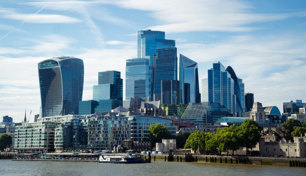 A beautiful view of the modern London skyline along the River Thames on a sunny day.